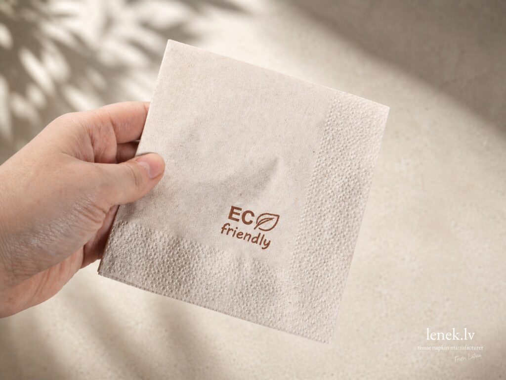 Kraft eco friendly recycled cellulose napkin held by hand, sustainable choice for restaurants and HoReCa